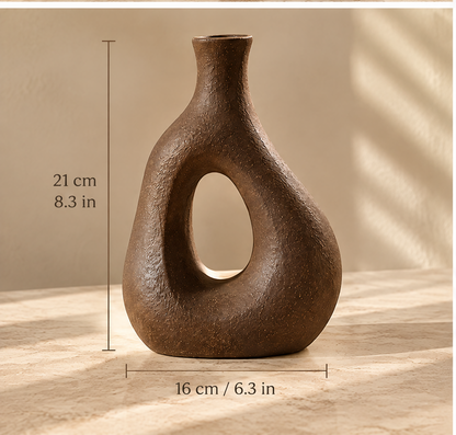 Brown textured vase lying on its side, showing its flat circular base.