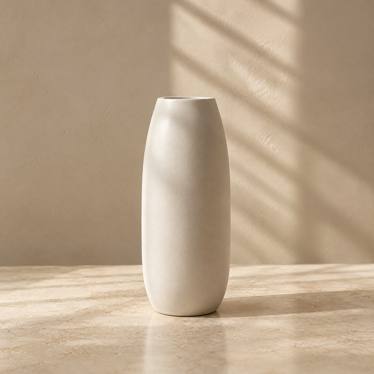 Tall ivory vase with gently curved sides on a sunlit tabletop.